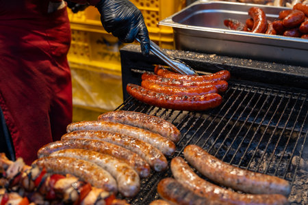 Fried sausages on the grill at a Christmas market at Prague. Czech Republicの写真素材