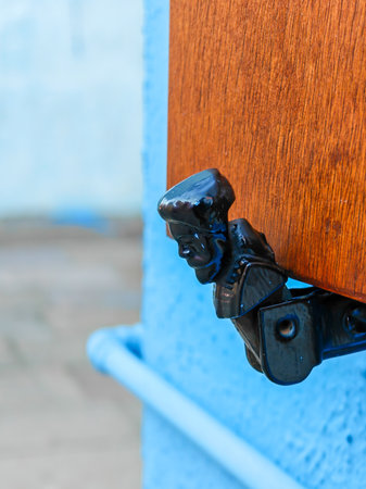 Iron window shutter holder head on house on Burano island. Venice. Italyの写真素材