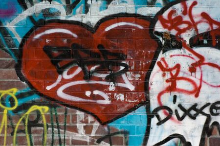 Texture of street graffiti showing a heart on a brick stone wall in Berlinの写真素材