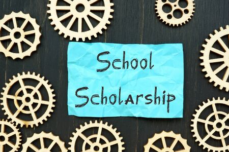 School Scholarship phrase on the piece of paper.