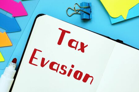 Business concept meaning Tax Evasion with sign on the piece of paper.の写真素材