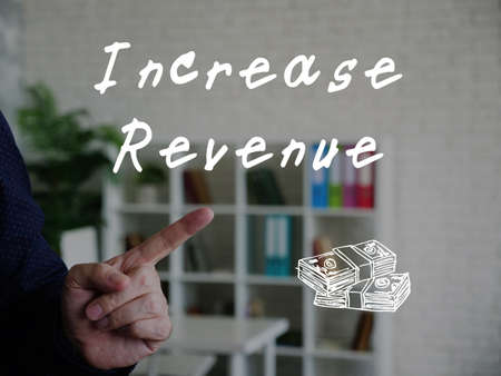 Business concept about Increase revenue with sign on the piece of paper.の写真素材