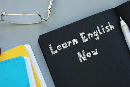 Conceptual photo about Learn English Now with handwritten phrase.の写真素材