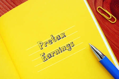 Financial concept meaning Pretax Earnings with phrase on the piece of paper.