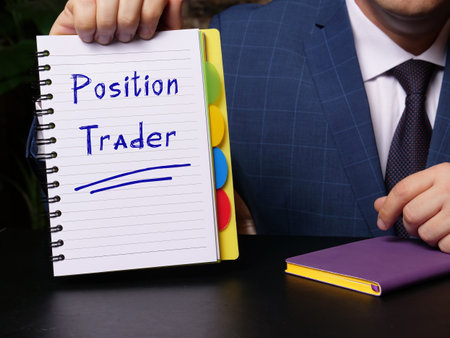 Business concept meaning Position Trader with phrase on blank notepad in hand.の写真素材