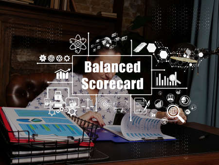 Financial concept about Balanced Scorecard with sign. young businesswoman working at modern office on background.の写真素材
