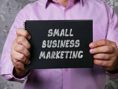 Financial concept meaning SMALL BUSINESS MARKETING with inscription on the sheet.の写真素材