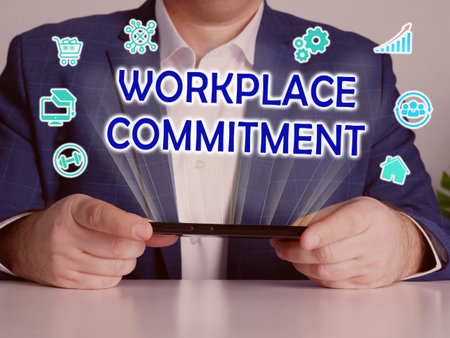 WORKPLACE COMMITMENT text in search bar. Businessman looking for something at laptop. WORKPLACE COMMITMENT concept.の写真素材