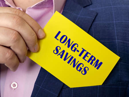 Business concept about LONG-TERM SAVINGS with inscription on the piece of paper.の写真素材
