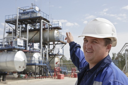 Oil worker in industrial oil and fuel plant Oil worker in industrial oil and fuel plant