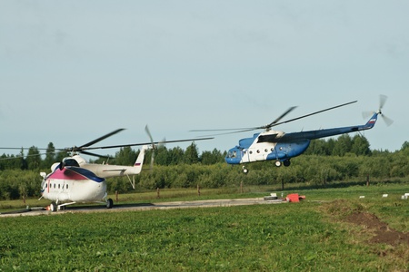 Two Helicopter on a platform before launch. One already in airのeditorial素材