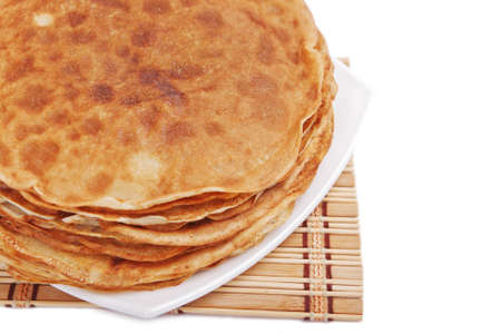 Tasty pancakes on plate with bamboo napkin