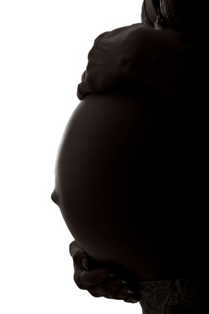 Silhouette of a stomach of the pregnant woman in a profileの写真素材