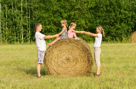 The family outdoors has rest on hayの写真素材