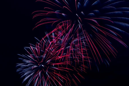 Brightly colorful fireworks and salute of various colors in the night skyの写真素材