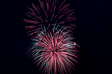 beautiful firework over the water in the night skyの写真素材