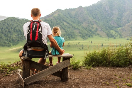 The family has rest on observation deck overlooking a mountain valleyの写真素材