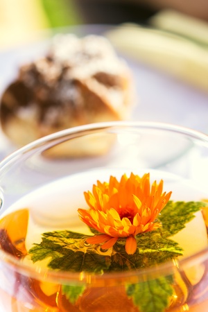Tasty tea with currant leaf in cup on tableの写真素材