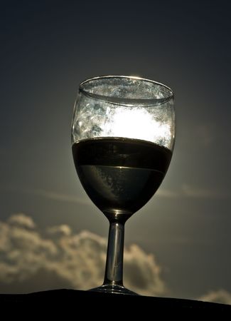 A glass of white house wine, taken at sunset on Madeira, Portugal.の写真素材