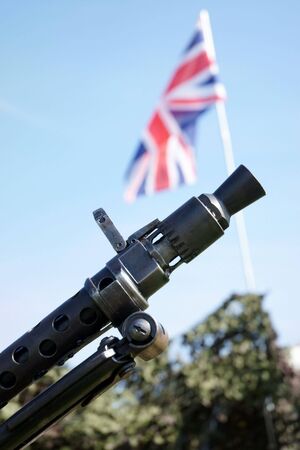 Machine gun used in the Second World War with the Union Jack flag in backgroundの写真素材