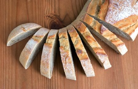 Sliced Stone-ground loaf on a wooden chopping boardの写真素材