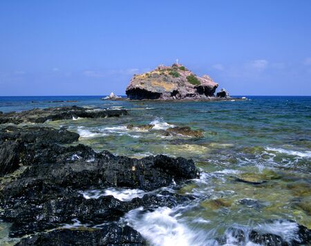 A small island close to the Baths of Aphrodite in Cyprusの写真素材