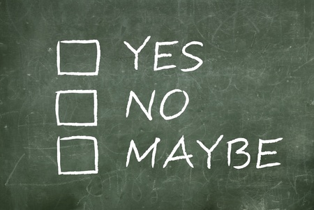 yes, no or maybe on a green blackboardの写真素材