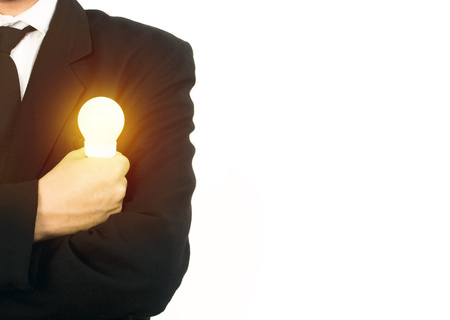 Business man holding Light bulbの写真素材