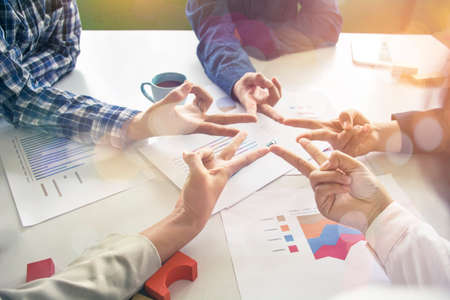 Five people engaged in hand with an asterisk