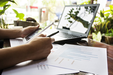 Businessman working generic design laptop. Touching screen smartphone. Horizontal mockup.の写真素材