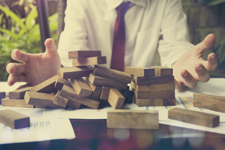 Failure Business,Problem Solving,business can't stop effect of dominoes continuous toppled with hand at desk,の写真素材