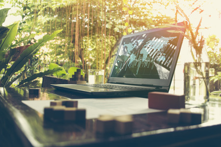 Workplace with laptop  table and books beside の写真素材