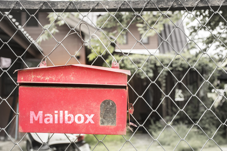Red mailbox On the fence.の写真素材