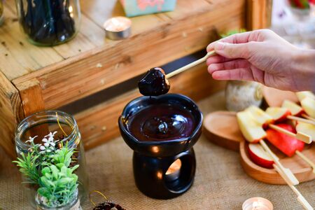 Chocolate cream and chocolate pieces on wooden table, top viewの写真素材