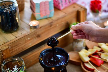 Chocolate cream and chocolate pieces on wooden table, top viewの写真素材