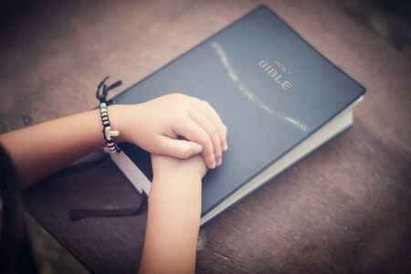 Little praying to God with hands held togetherの写真素材