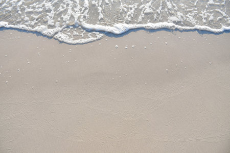Soft Blue Ocean Wave On Sandy Beach. Background. Selective focus.の写真素材