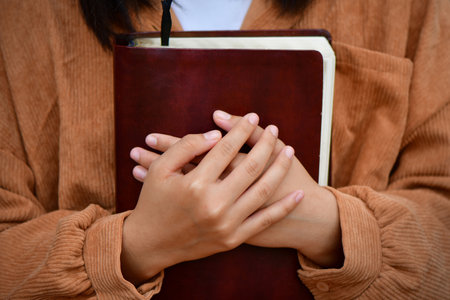 young woman hugging bible and praying to god. Christian Concepts.の写真素材