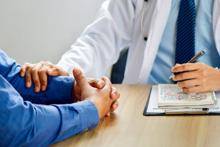 Hands of unknown man-doctor reassuring her female patient, close-up. Medicine concept. listen, see doctor at hospital.の写真素材