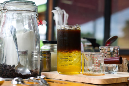 Iced black coffee mixed with honey in a glassの写真素材