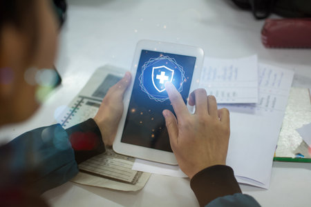Smart hand touch on First Aid icon from tablet computer.
