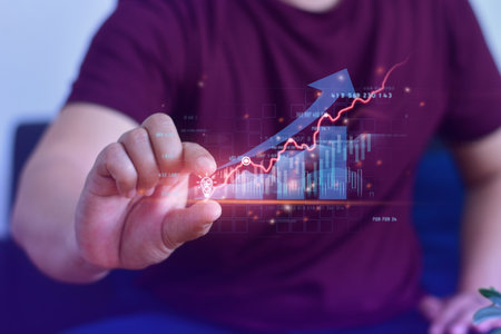 Businessman holding creative light bulb with growth graph and banking icons. Financial innovation technology develop new products and services that enhance successfulの写真素材