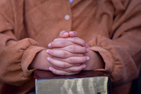 woman's closed hand is prayer and thank God.の写真素材