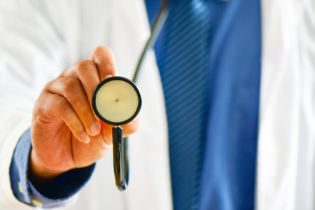 A doctor with stethoscope. Doctor using stethoscope in hospitalの写真素材