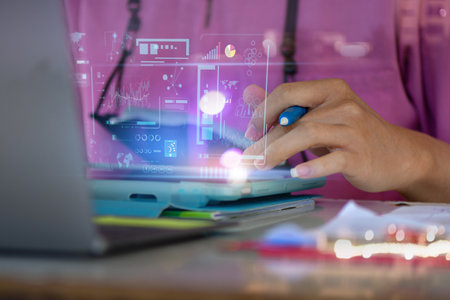 Programmer using laptop analyzing and development at various information on futuristic virtual interface screen. marketing and deep learningの写真素材