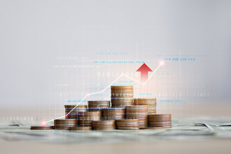 Coin stack with growth chart and graph progress , Stack of silver coins with trading chart in financial concepts and financial investment business stock growthの写真素材