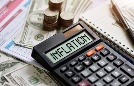 Calculator with currency glass jar and gold coins stack, Taxes and profits to invest in real estate and home buyingの写真素材
