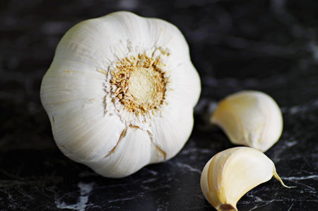 Garlic. Organic garlic on black rustic background. Organic spices.