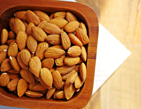 Almonds organic in wooden bowl for your healthy.の写真素材