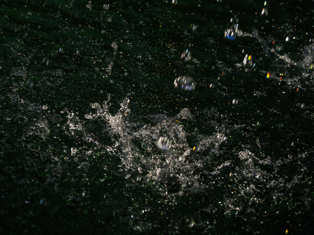 Splashes of blue water in the poolの写真素材